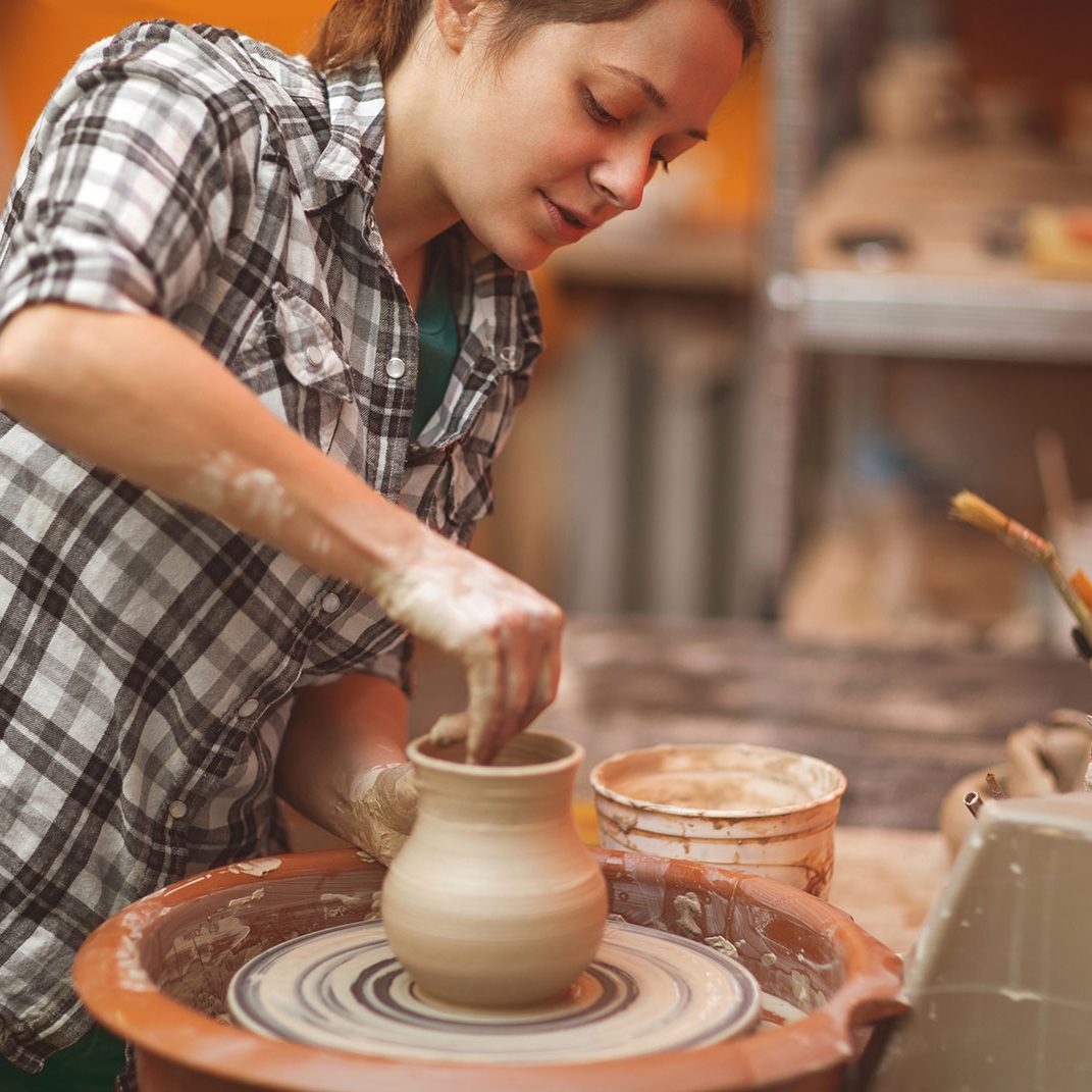 woman creating a clay sculpture